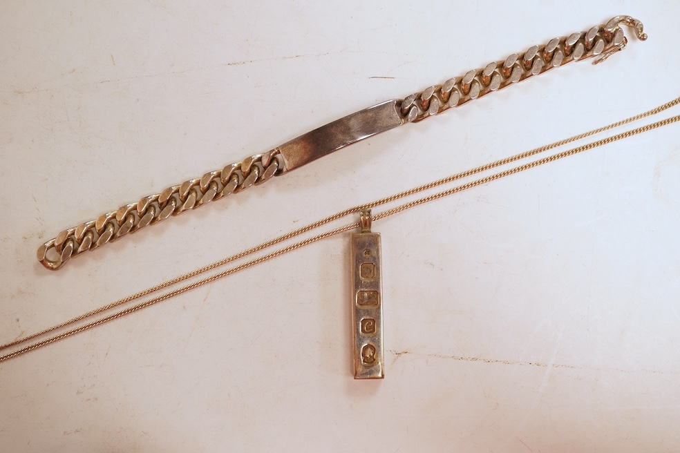 A silver necklace and bracelet, comprising: a silver ingot pendant necklace, pendant length 5.2cm including bail; and a silver curb link ID bracelet, length 20cm, each with British hallmarks, combined gross weight 82 gra